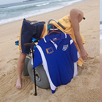 Prosthetic limbs, beach wheelchair and walking cane on a beach