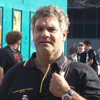 Richard wearing a black Illawarra Aboriginal Community shirt