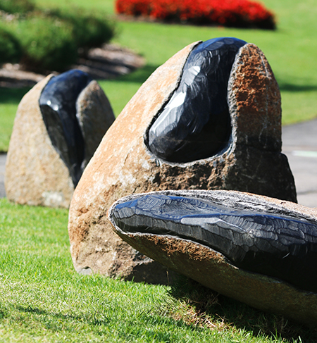 detail of Andreas Buisman's sculpture showing three large rocks with coal cross-sections