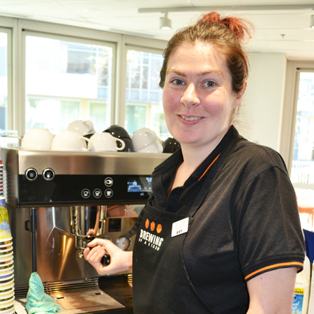 Jessica working at a coffee machine