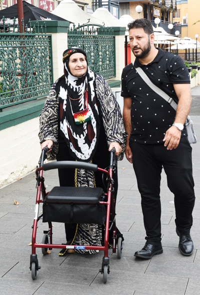 Nura and Manhal walking on a footpath