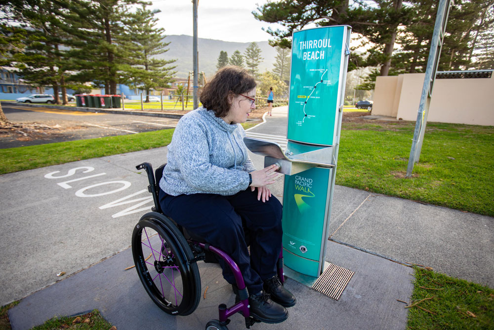 Woman in wheelchair using water bubbler