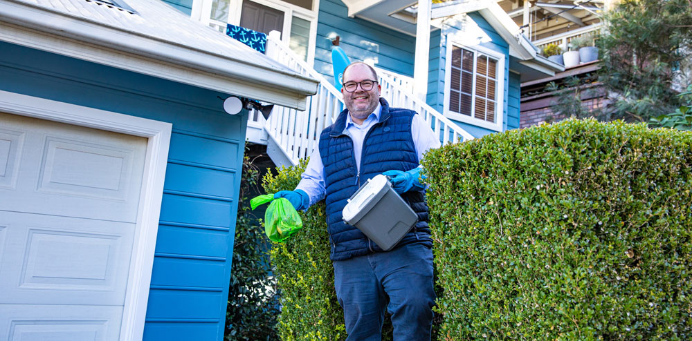 man in front of house using FOGO